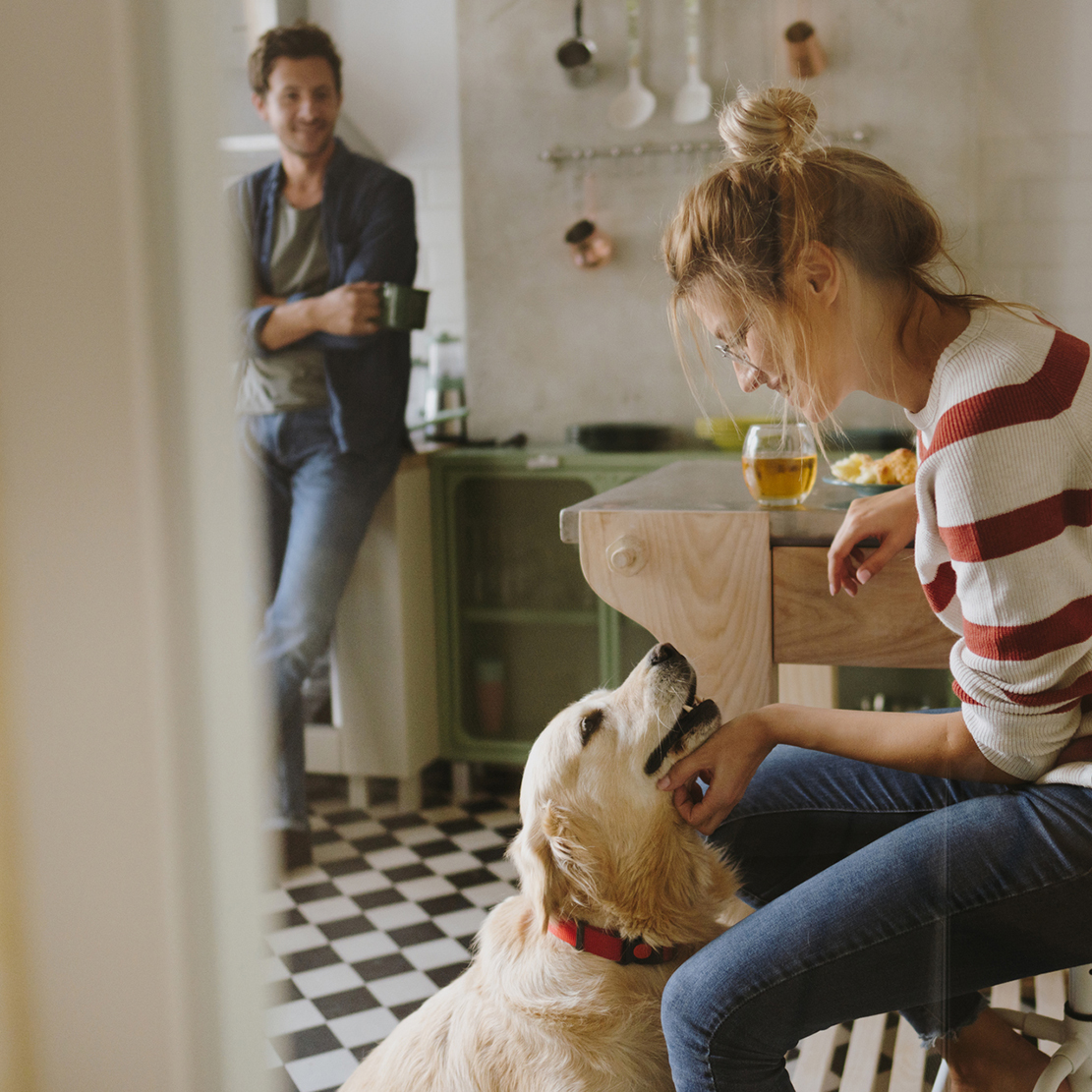 what young adults need to know about generational changes in spending habits_young woman smiling while petting her dog