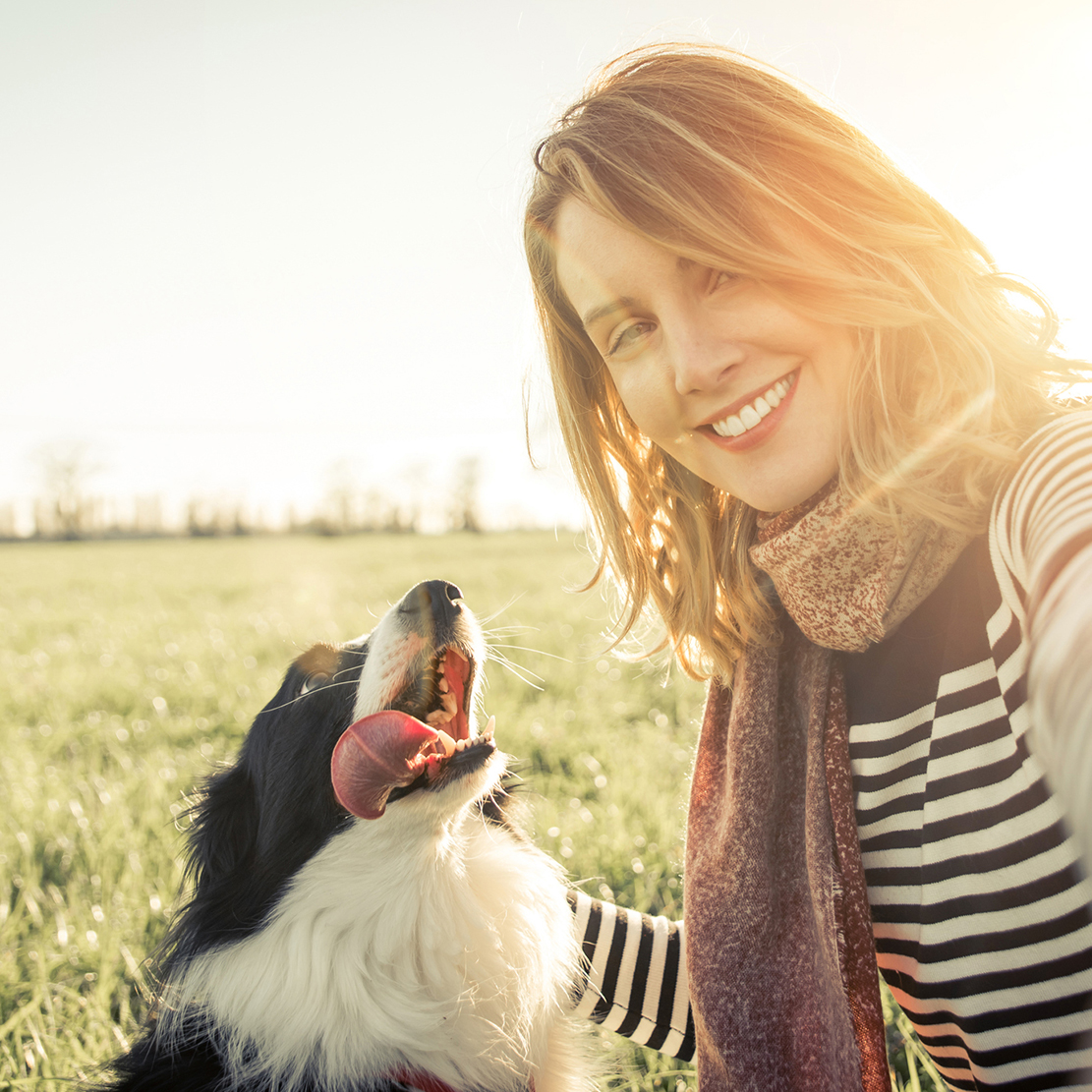 young woman taking a selfie with her dog