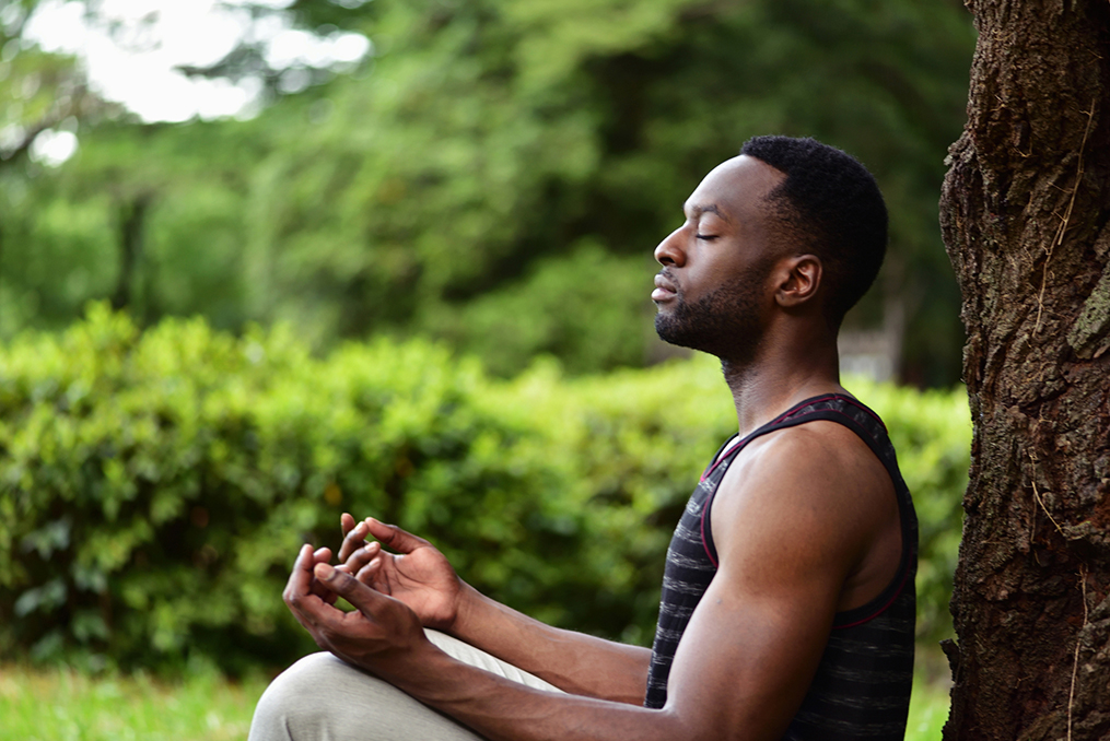 Commit to Getting Financially Fit in 2020_main in yoga pose meditating next to tree