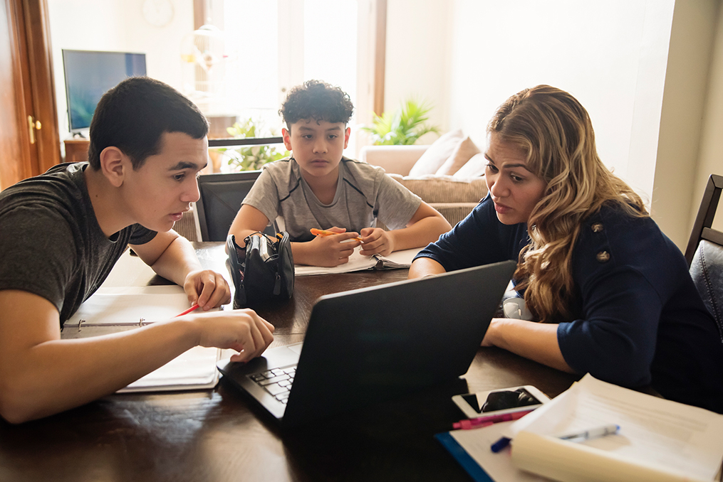 Essential Tips for Securing Your Family's Mobile Devices_Mother talking with two sons about mobile device security