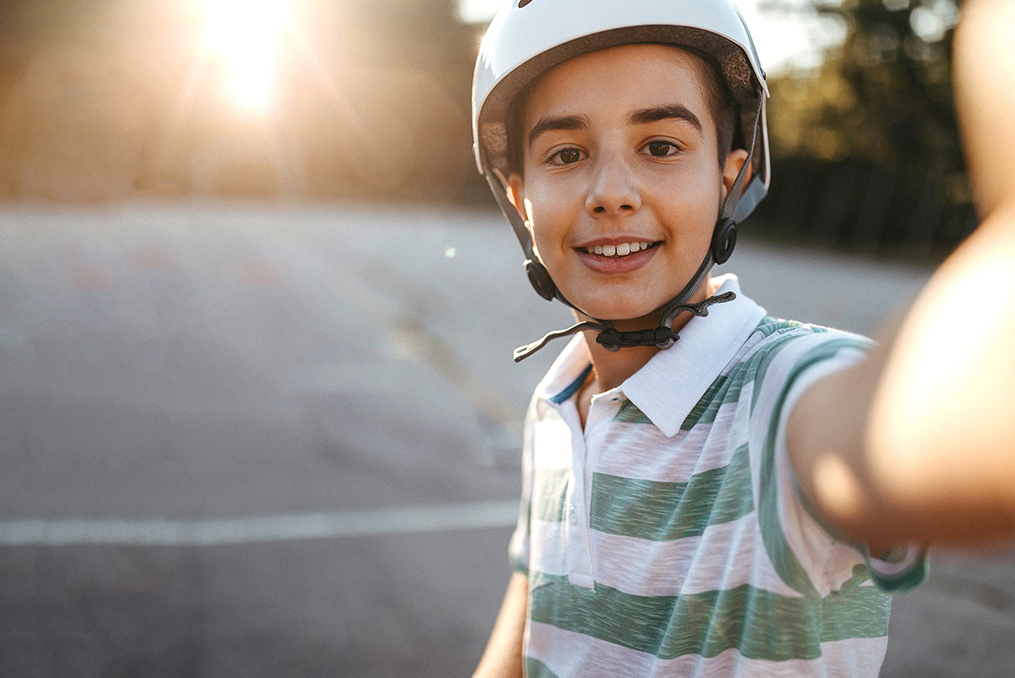 Essential Tips for Securing Your Family's Mobile Devices_Teen boy taking selfie with mobile phone