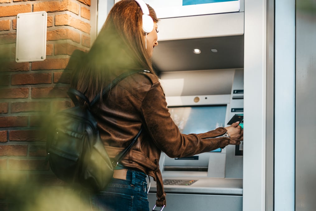 How to avoid ATM fees_woman using ATM