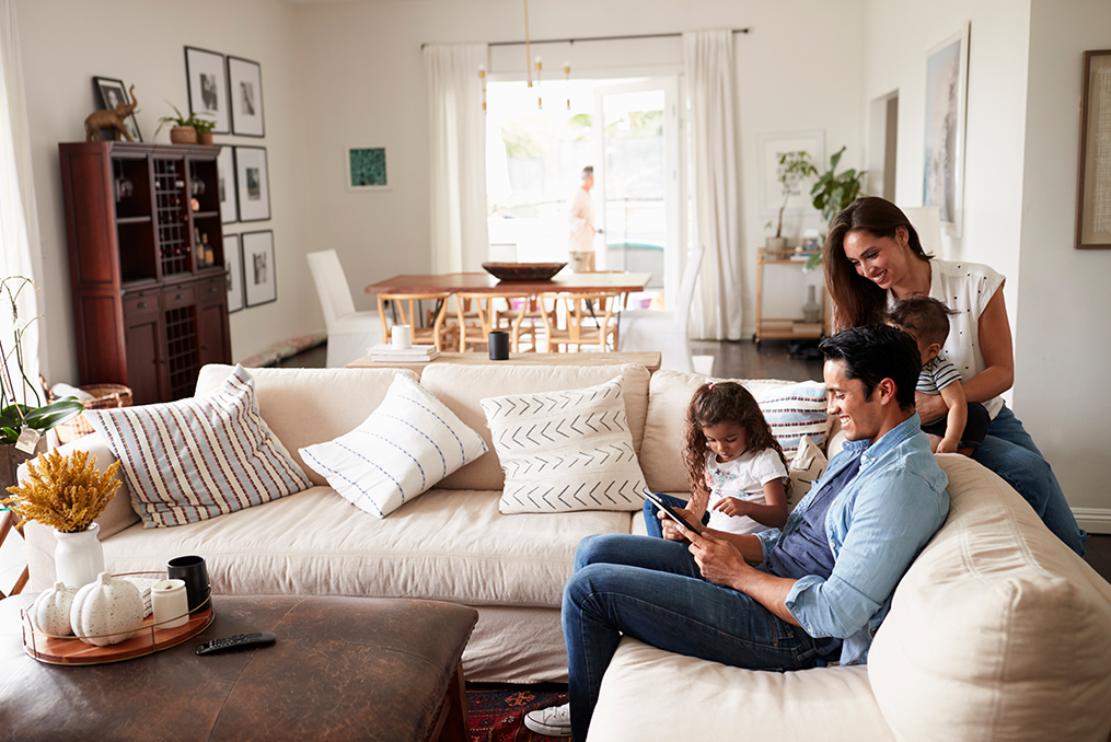 What You Should Consider When Buying Life Insurance_Young family reviewing insurance options in their living room