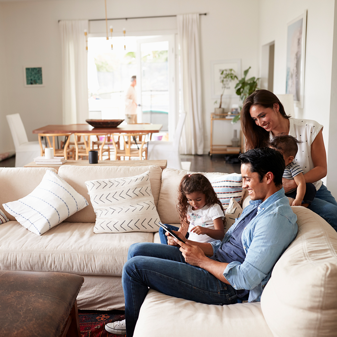 What You Should Consider When Buying Life Insurance_Young family reviewing insurance options in their living room