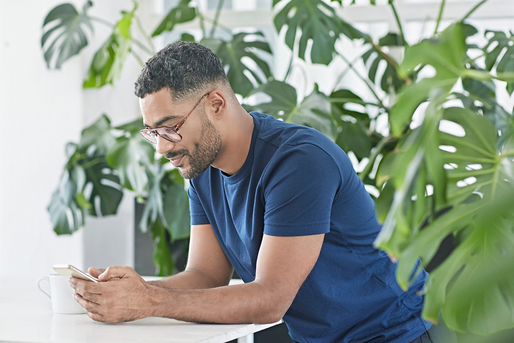 how to prevent peer to peer payment fraud_man smiling while looking at his phone