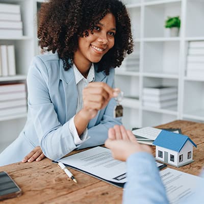 Mortgage lender handing over keys to new home onpoint