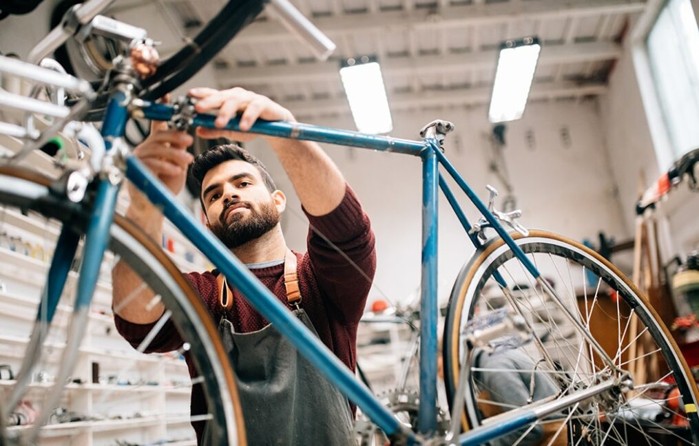 Business Financing Landing Page-man working on a bike in his shop