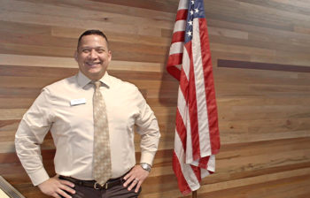 Nick Styles military veteran photo with American Flag in OnPoint HQ Lobby_1049x670