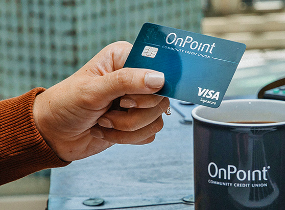 OnPoint Signature Visa with Cash Back Rewards card held in woman's hand