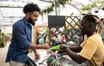 man paying with phone at plan shop onpoint checking