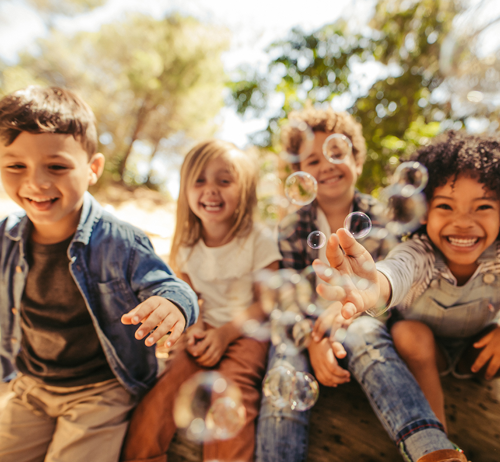 Group of children playing with soap bubbles