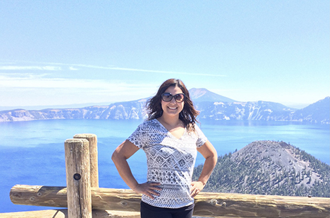 Marlen posing in front of a scenic mountain and lake view in the pacific northwest crater lake