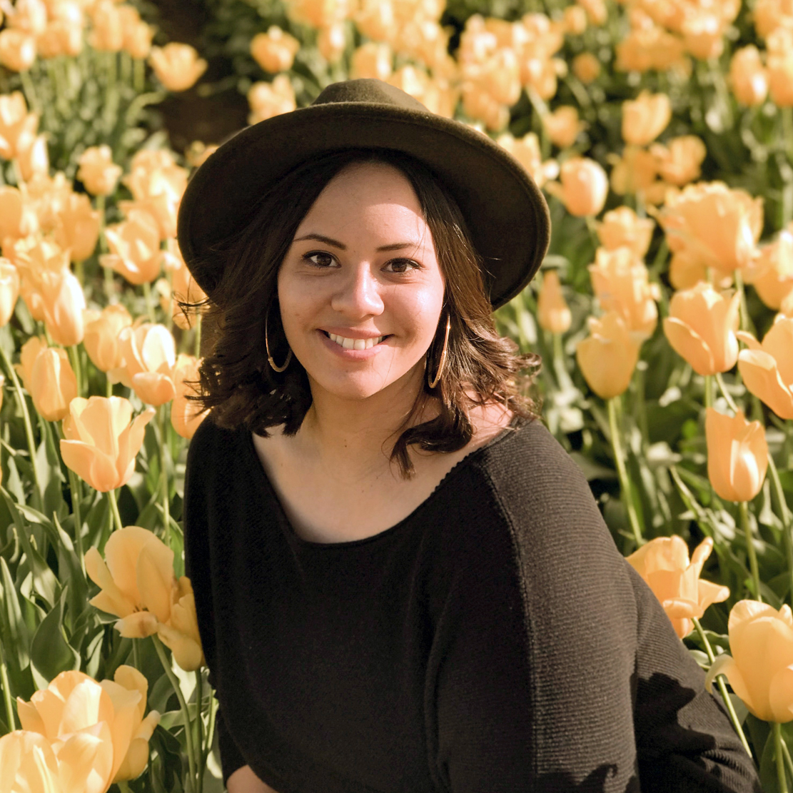 Chelsea Johnson headshot among a field of flowers
