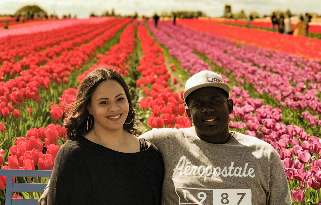 Chelsea Johnson with her husband in a field of flowers