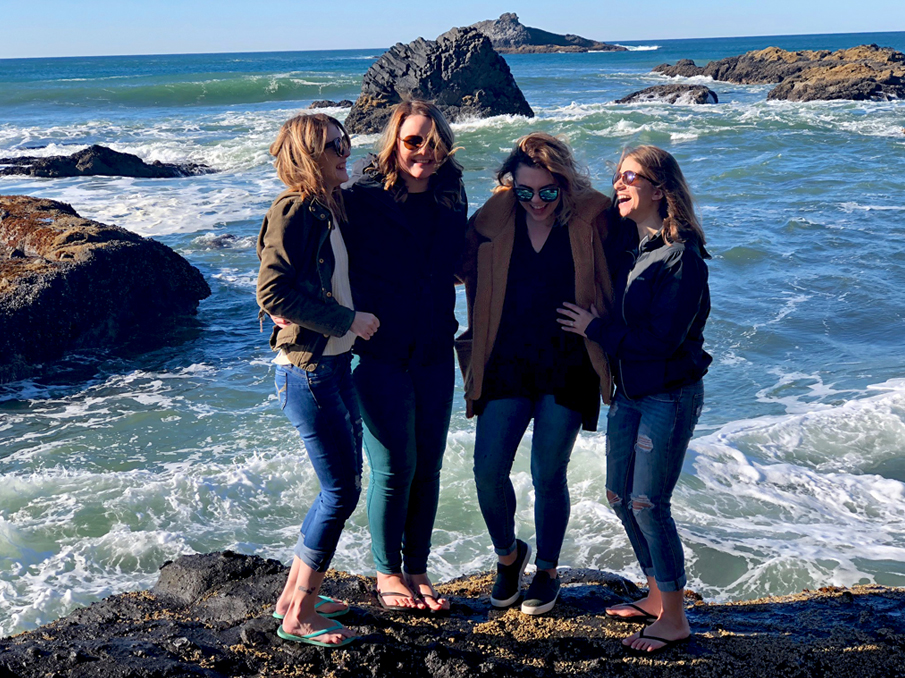 Abbygale standing with a group of friends near the ocean