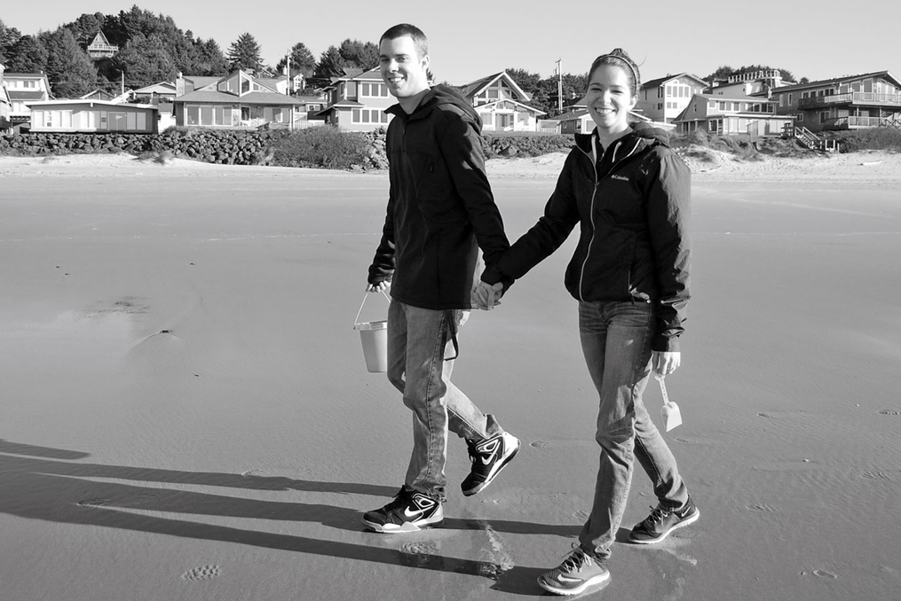 Abbygale walking along the beach with her partner