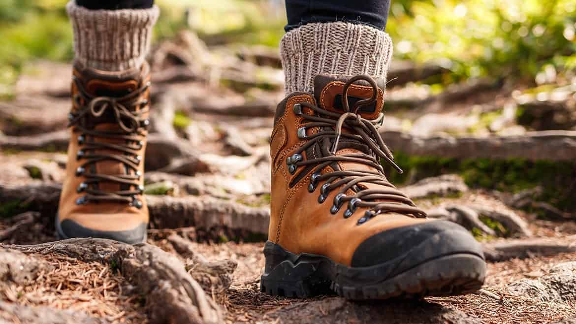 leather-hiking-boots-walking-on-mountain-trail