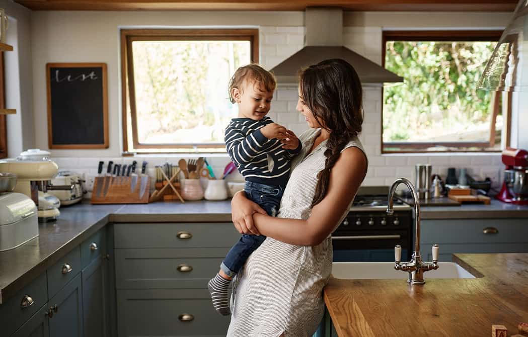 Woman with baby in kitchen