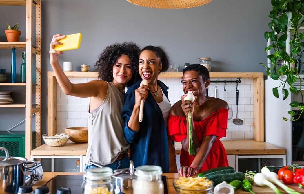 Friends cooking together taking a selfie being silly