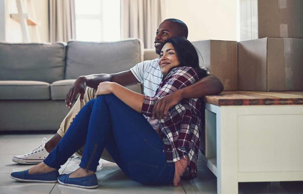 couple sitting on the floor at their new condo