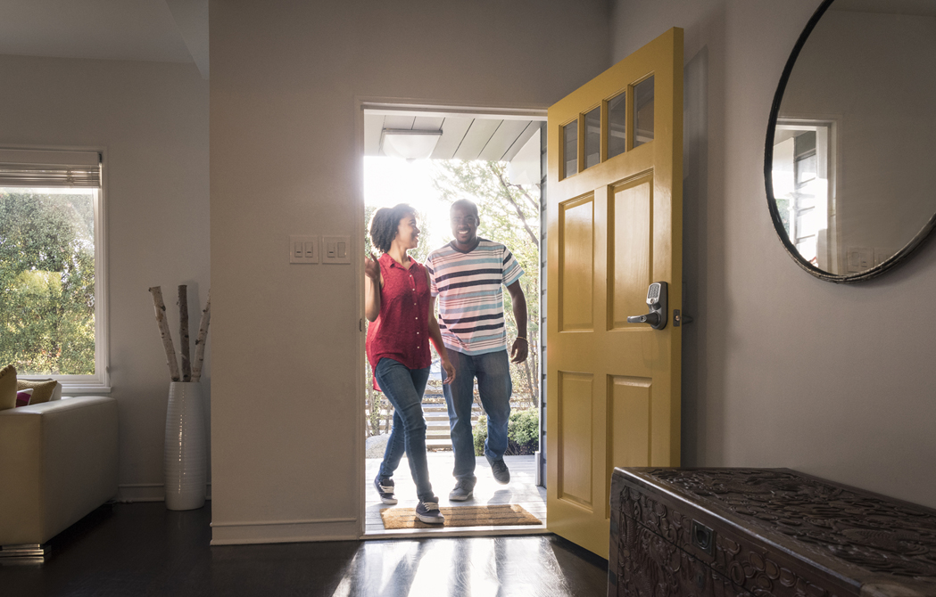 couple walking through the door of their home