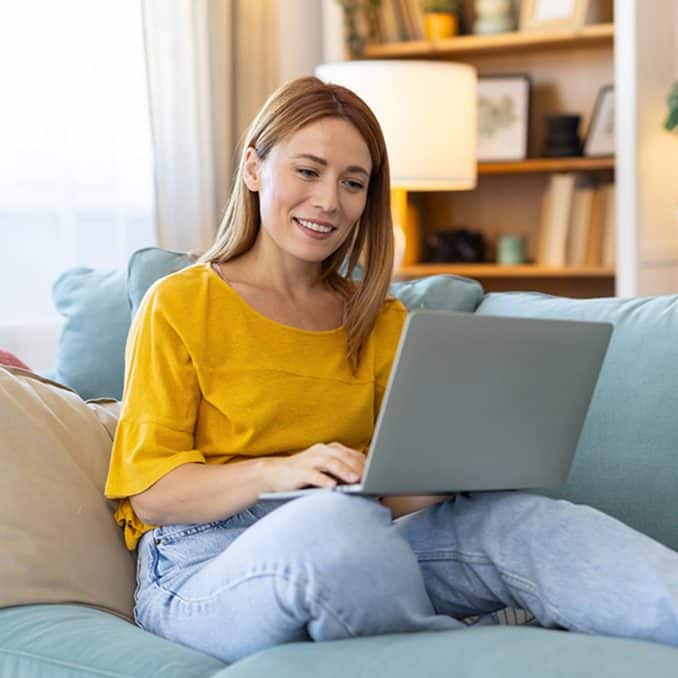 Financial Wellness free ebook download 2025 girl with yellow shirt on couch with computer