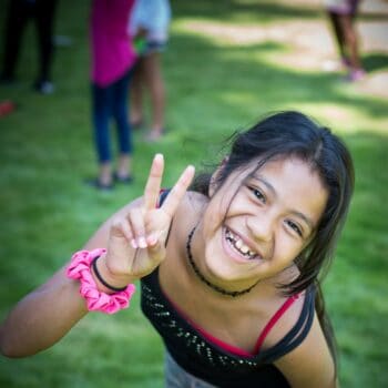 girl smiling with peace signs