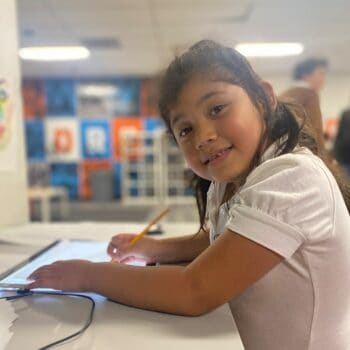 _Girl-smiling-at-camera-while-at-school