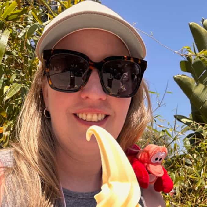 Trisha Stout with money on her shoulders and holding ice cream