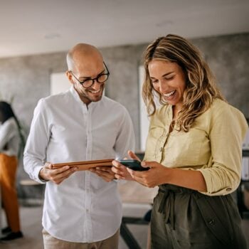 two-people-looking-at-a-tablet