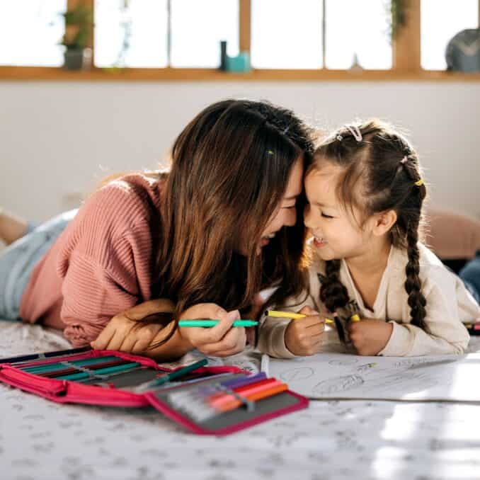 Affectionate mother and daughter drawing