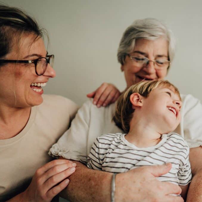 intergenerational-connections_child-held-by-grandma-and-mom