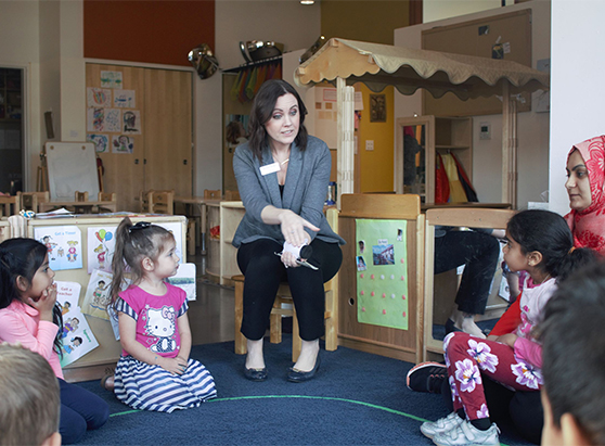 Woman reading to a group of children