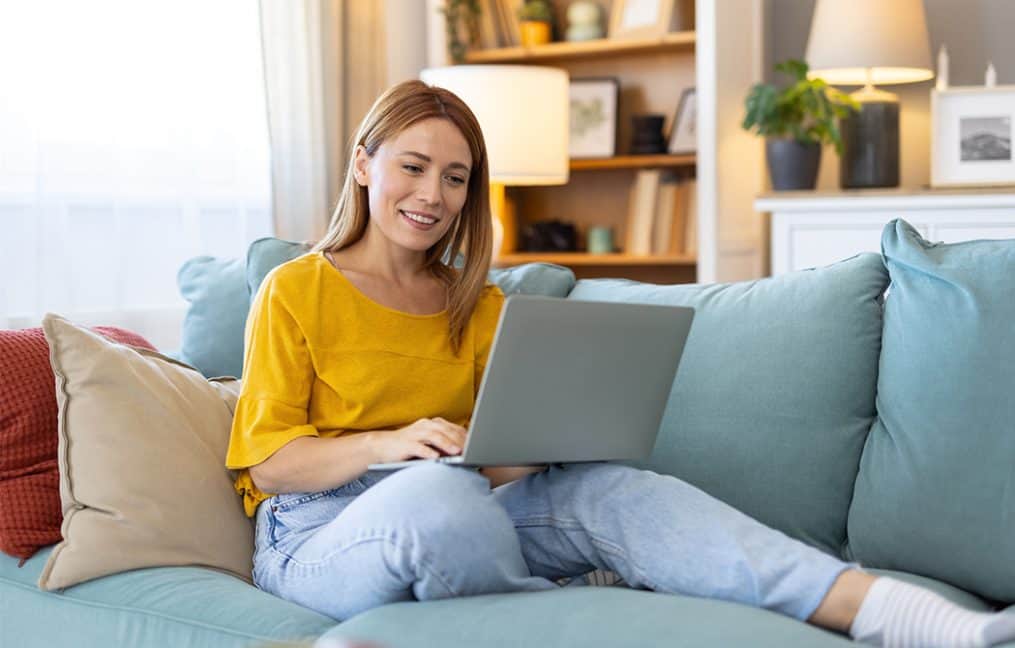 Financial Wellness free ebook download 2025 girl with yellow shirt on couch with computer