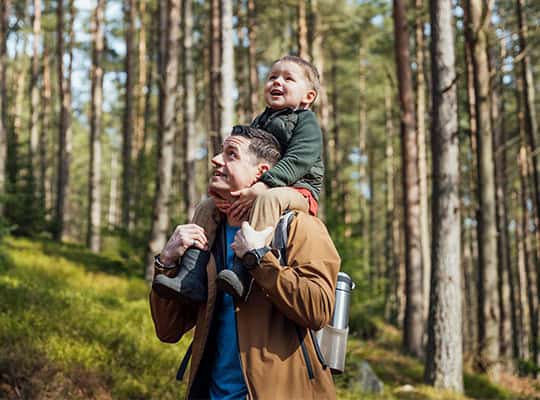 Financial counseling at onpoint community credit union green path baby on dads shoulders hiking through forrest