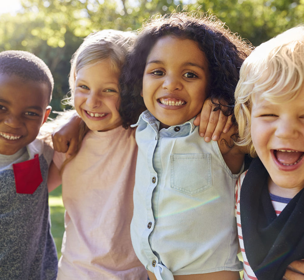 Four kids hanging out together in the garden
