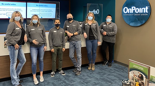 Team members of the OnPoint Salmon Creek Branch line up to celebrate the opening of their new branch.