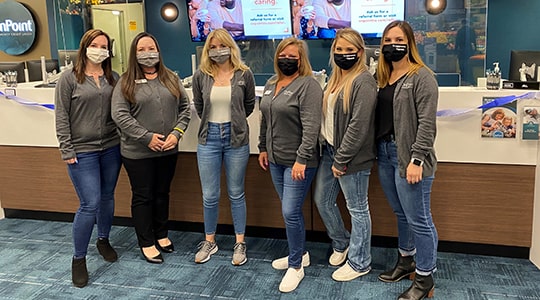 Team members of the OnPoint Scappoose Branch line up to celebrate the opening of their new branch.