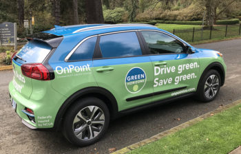 Kia electric vehicle with OnPoint Green Horizons logo and branding.