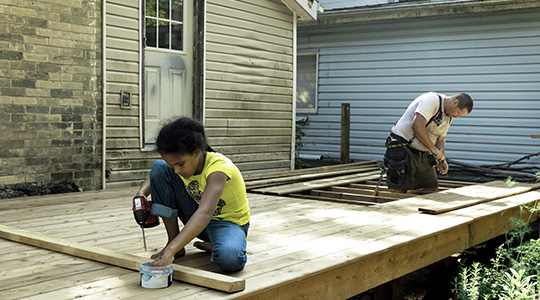 Father and daughter building a backyard deck using funds from the HELOC on their home
