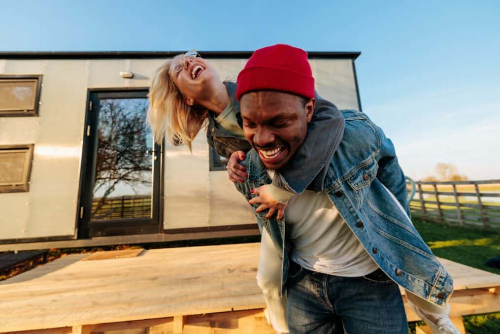 Couple piggy back ride laughing