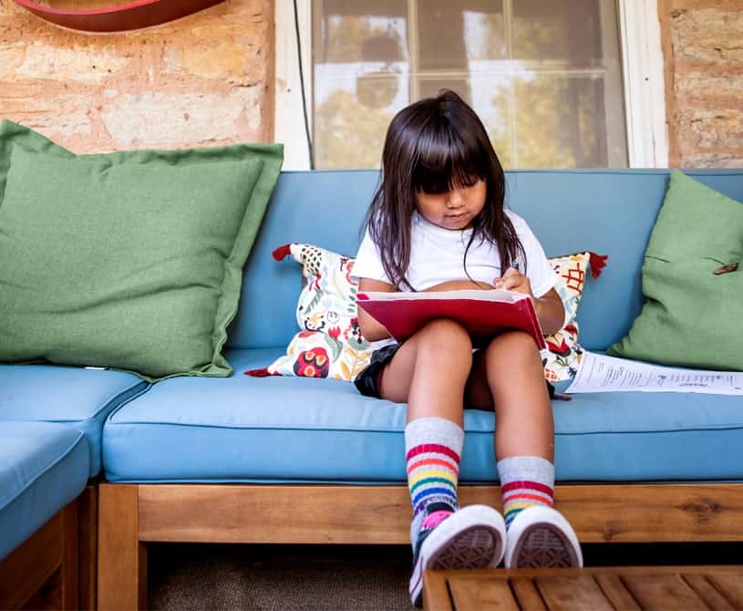 Youth-sitting-outside-completing-their-homework