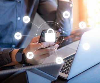Man on laptop and phone with security-related icons appearing on photo
