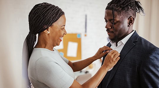 mother helping son button up dress shirt onpoint raymond james investment oregon washington