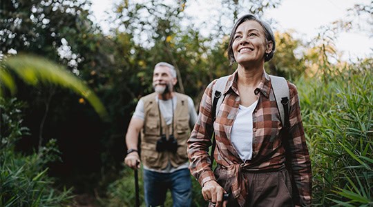 woman and man hiking in forest onpoint raymond james investments oregon washington