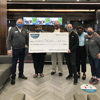 Lloyd Center branch staff present a check to Children's Book Bank