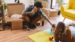 couple packing up their apartment and playing with their little baby