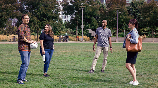 group of friends hanging out in the park talking about local banking options