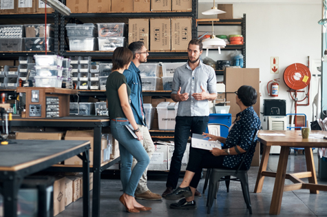 Employees discussing group banking in the warehouse