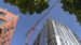 skyward view of two building construction projects and crane